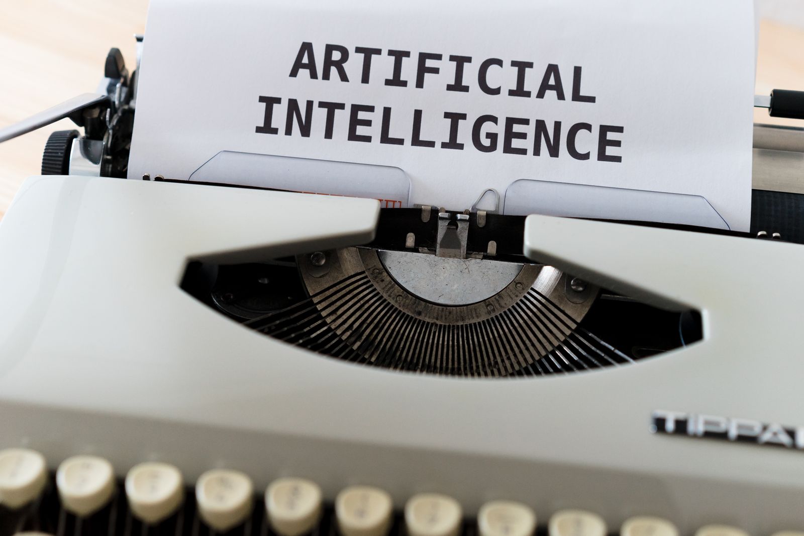 Close-up of a typewriter with the words Artificial Intelligence typed on paper, illustrating AI ad creative tools